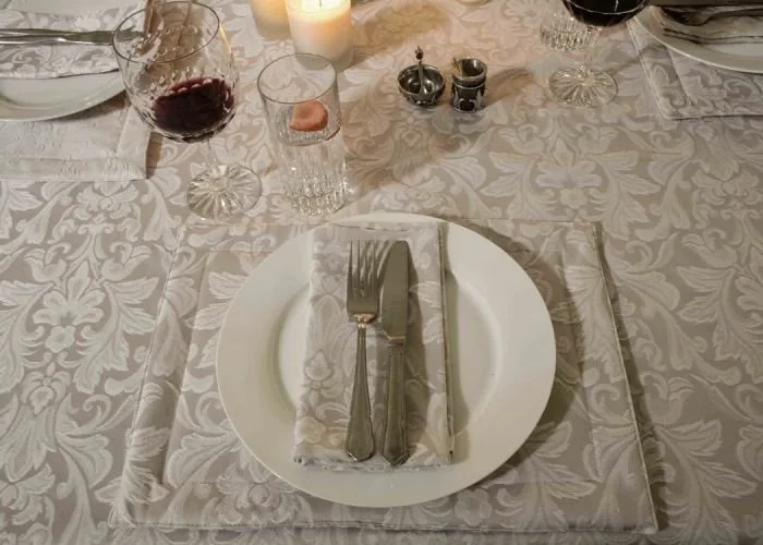 Various uses of damask fabric including table linens, curtains, upholstery, and bedding in home decor