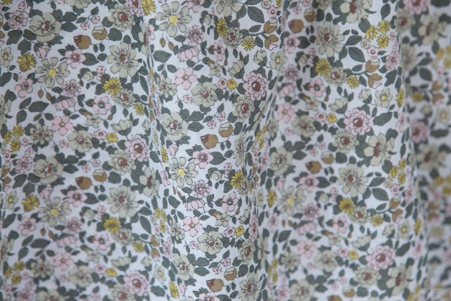 Cotton chintz fabric with a dense floral print in muted tones.