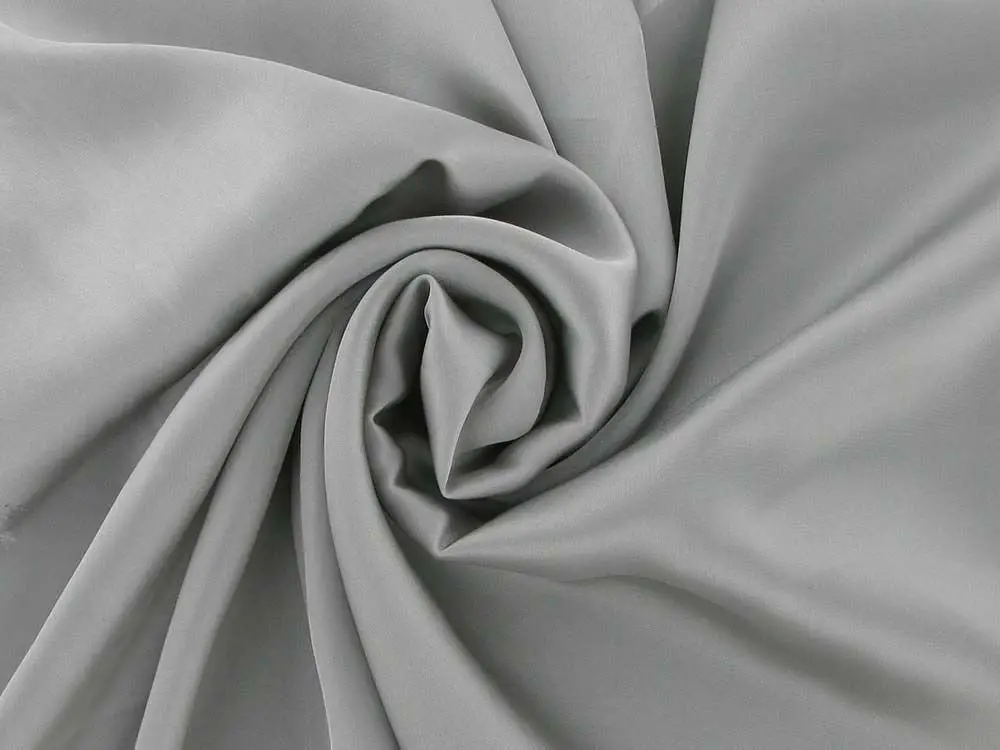 Smooth grey charmeuse satin fabric with soft draping folds