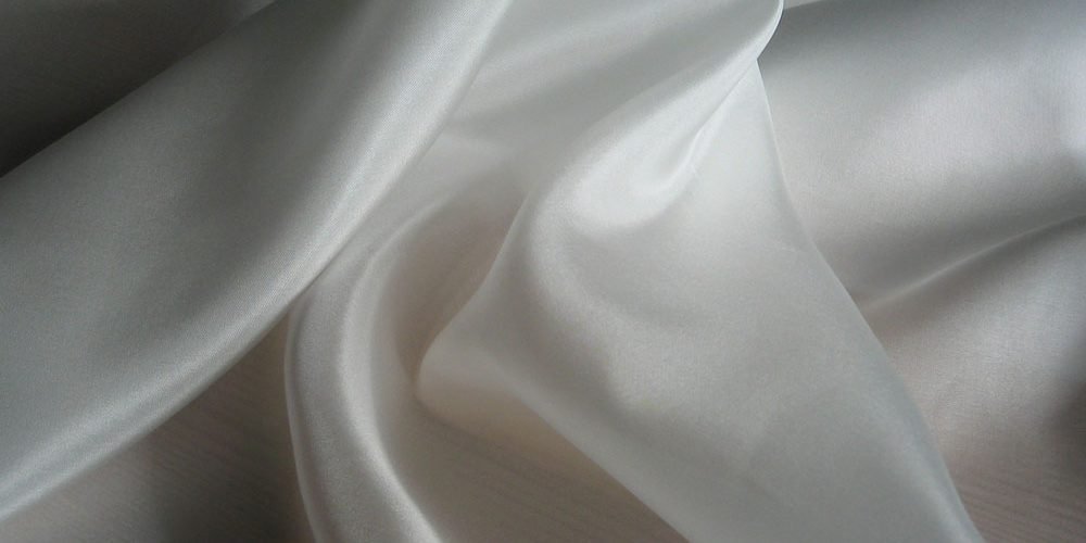 Soft white habotai silk fabric with a smooth flowing texture ideal for sewing and lightweight garments