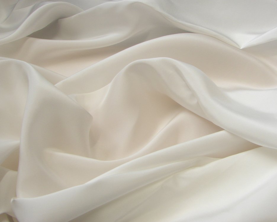 Close up of white habotai silk fabric with soft waves and a natural sheen