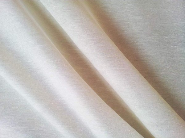 Ivory hemp silk charmeuse blend fabric with a matte, lightly textured surface and graceful folds