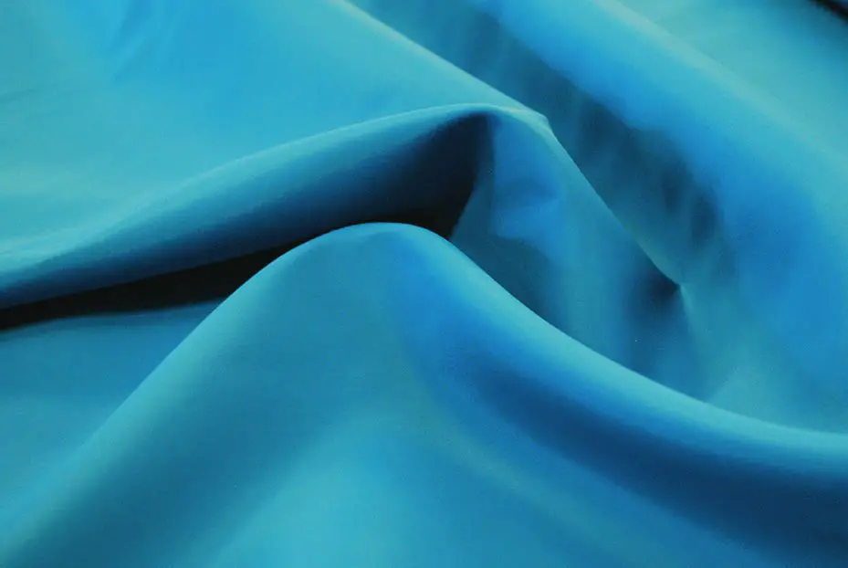 Smooth blue nylon taffeta fabric with soft ripples and a matte shine