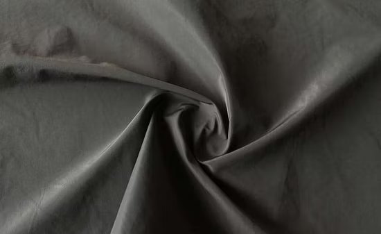 Black recycled polyester taffeta fabric twisted into a swirl to show texture and sheen