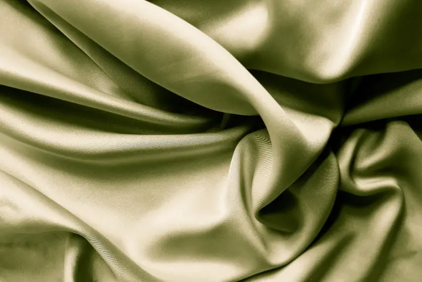 Olive green silk blend duchess satin fabric with soft folds and subtle sheen