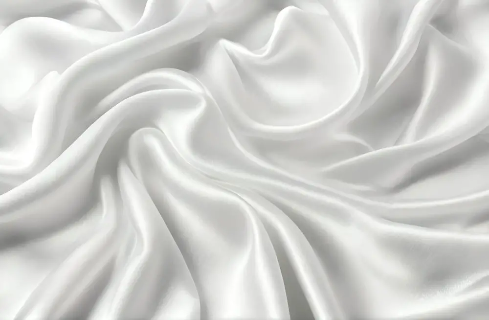 White silk slipper satin fabric draped in soft, luminous folds
