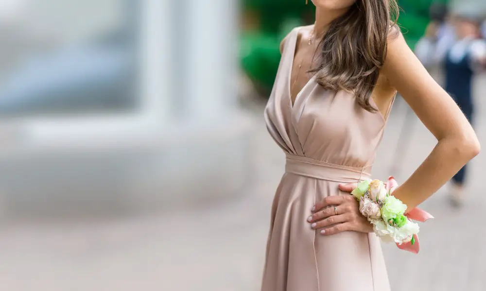 Woman wearing a blush satin dress styled for a formal fashion event