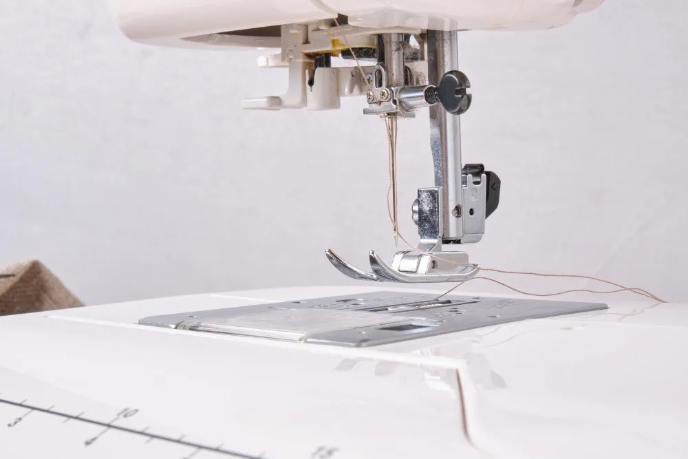 Close-up of a sewing machine needle with organza fabric, showing precision sewing setup