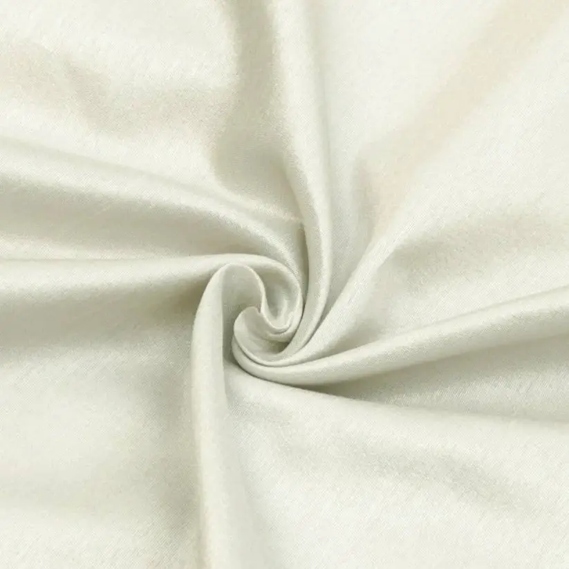 Close up of ivory art silk fabric with a smooth swirl pattern highlighting its sheen