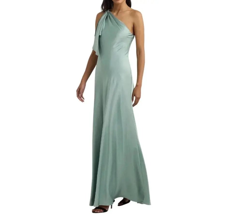 Woman wearing a long sage green charmeuse gown featuring a one shoulder design and elegant drape