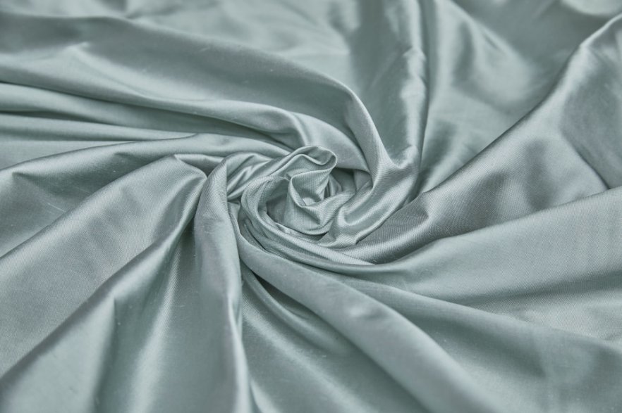 Close up of light blue Dupioni silk fabric with natural slub texture