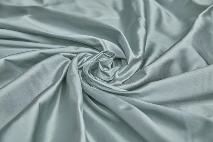 Close up of light blue Dupioni silk fabric with natural slub texture