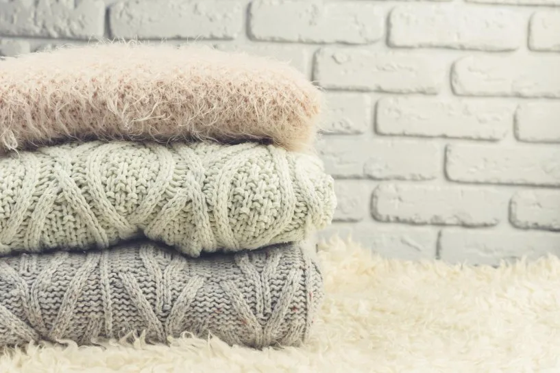 Folded mohair garments arranged for proper storage and care