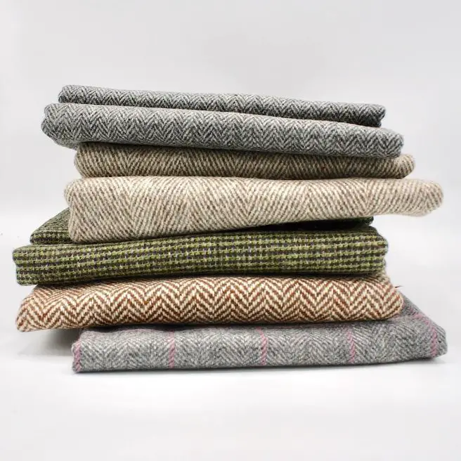 Stacked tweed fabrics showing texture and thickness for proper care guidance