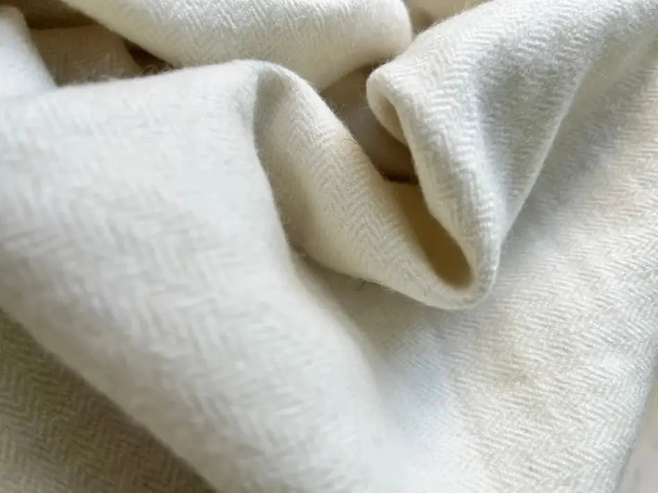 Merino wool fabric with a smooth knit texture and flexible drape