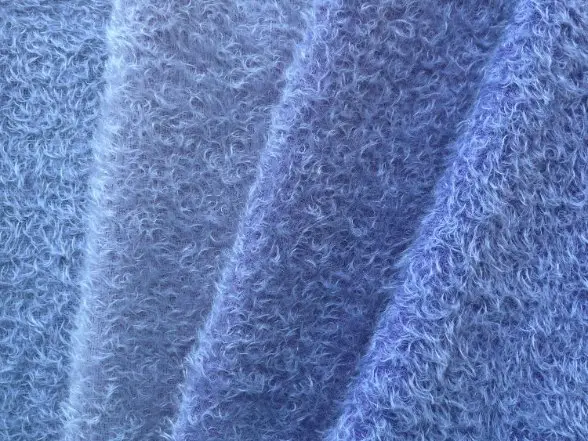 Close up of blue mohair wool fabric showing soft fuzzy texture