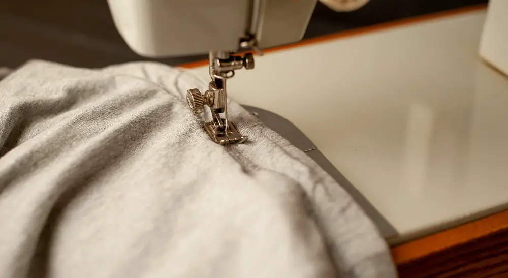 Sewing machine stitching soft cashmere fabric during garment construction