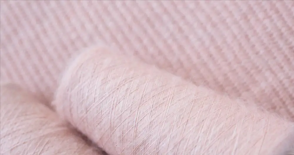 Close up of merino wool fabric being stitched during sewing process