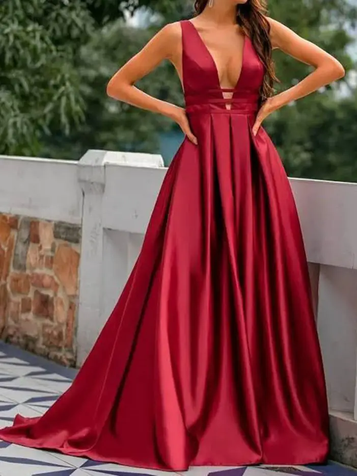 Woman wearing a deep red satin evening gown with a full skirt and plunging neckline