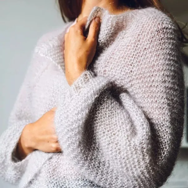Person wearing a soft mohair knit sweater showing texture and warmth