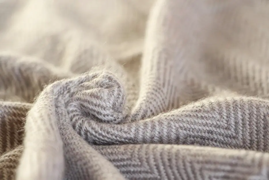 Close up view of wool fabric texture with soft natural fibers