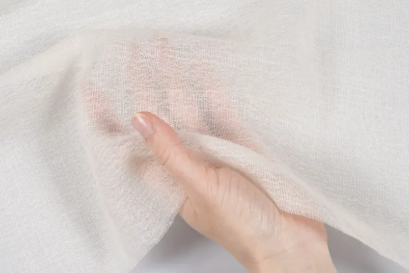 Sheer wool gauze fabric showing transparency and lightweight weave