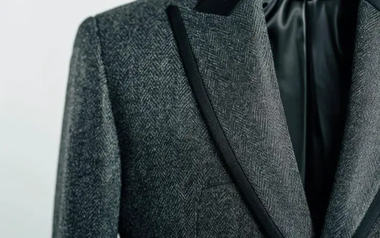 Wool suiting fabric used in a tailored jacket with refined texture