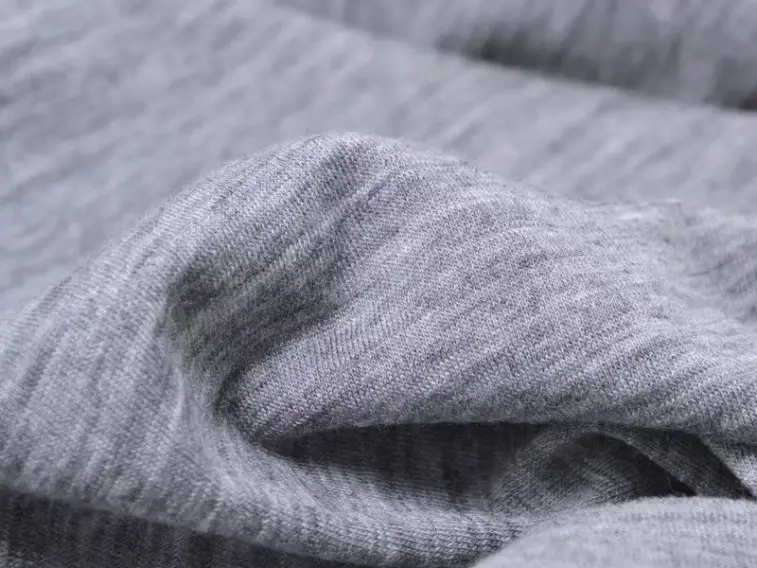 Wool jersey fabric with smooth knit structure and stretch