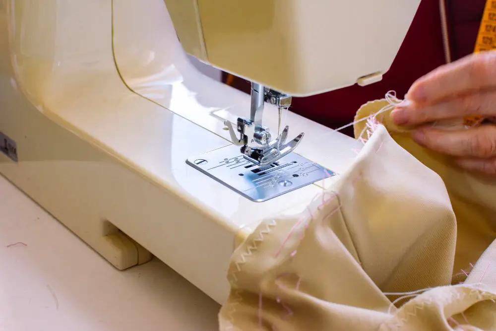 Close up of a sewing machine stitching delicate fabric, illustrating sewing techniques for acetate material