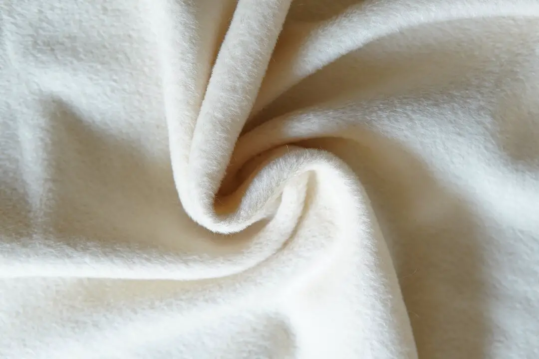 Close up of alpaca wool fabric showing soft texture and natural fibers