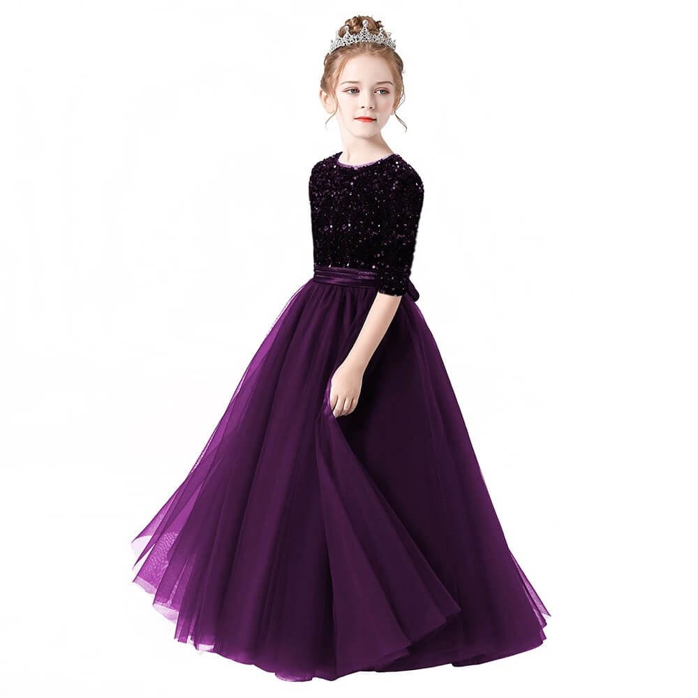 Junior bridesmaid wearing a long sleeve dark purple formal dress with full skirt