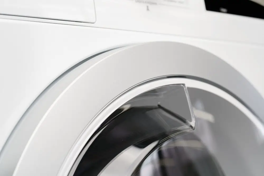 Front loading washing machine door showing a clean drum used for gentle fabric care