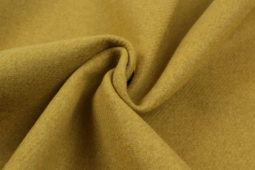 Recycled wool fabric with a textured surface in earthy yellow tones