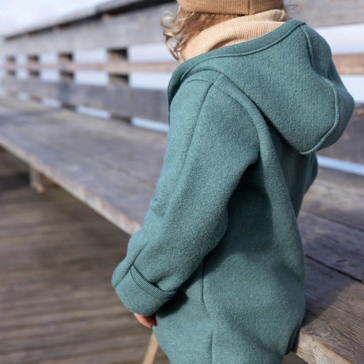 Child wearing boiled wool clothing showing comfort, warmth, and flexible fit for everyday wear. Credit: Woollykins