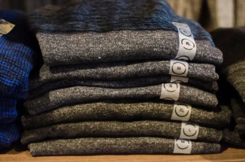 Stacked wool garments illustrating a buying guide for choosing high quality wool gabardine fabric
