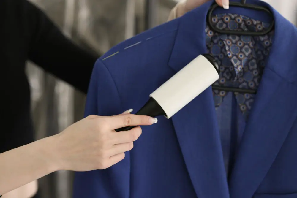 Lint roller being used on a wool gabardine blazer to demonstrate proper fabric care
