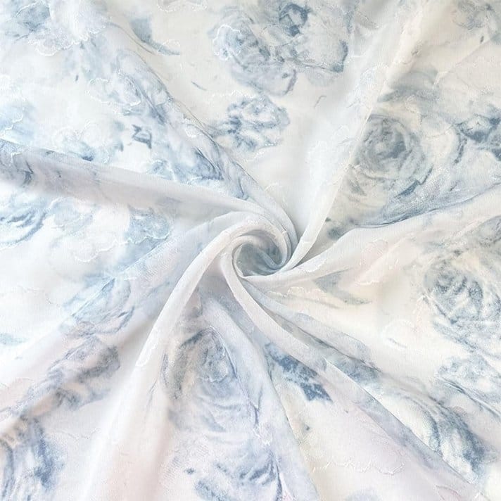 Floral jacquard chiffon fabric with soft blue flower pattern and sheer lightweight drape