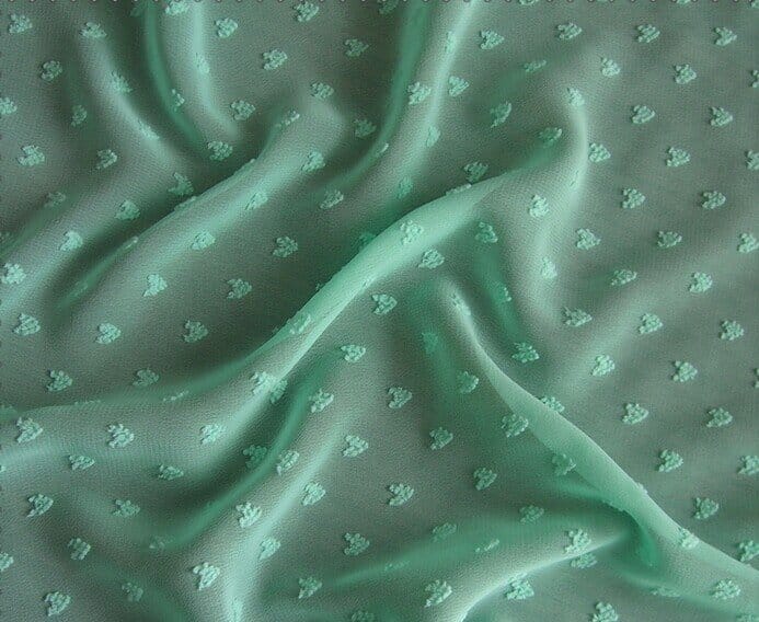 Polyester jacquard chiffon fabric with textured woven dots and lightweight drape