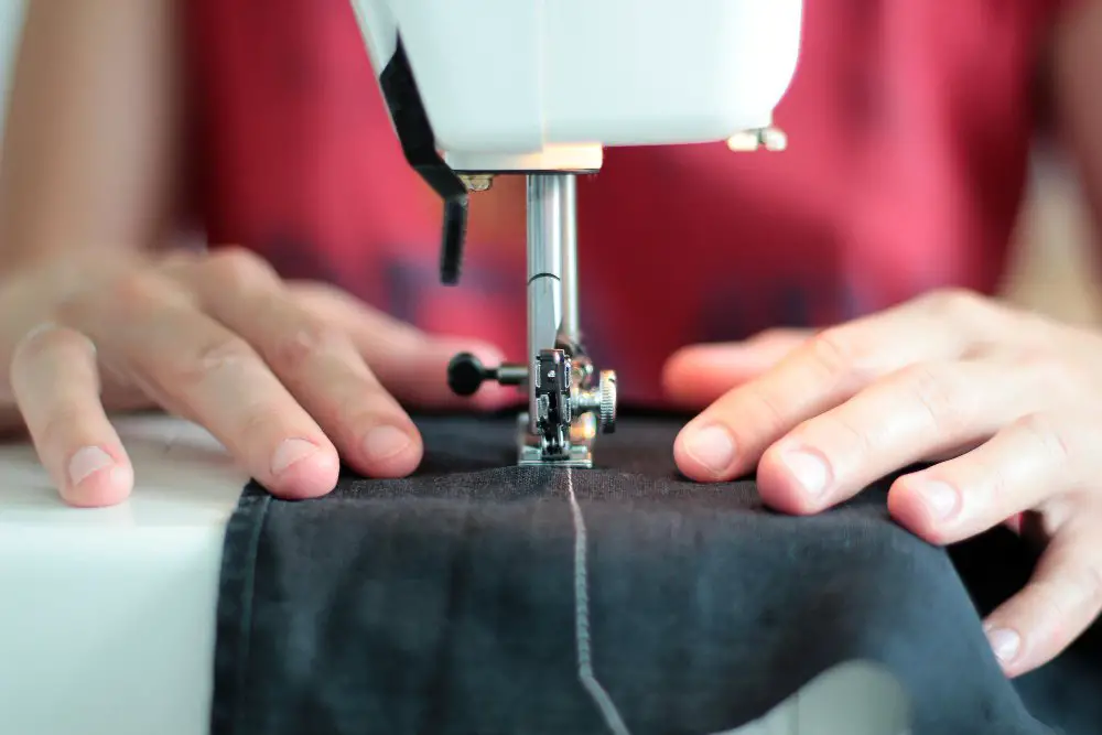 Close up of sewing wool gabardine fabric on a sewing machine during garment construction