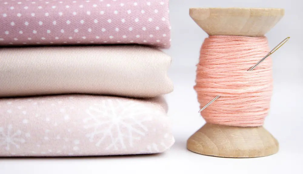 Fabric stack and sewing thread prepared for sewing projects using wool delaine fabric