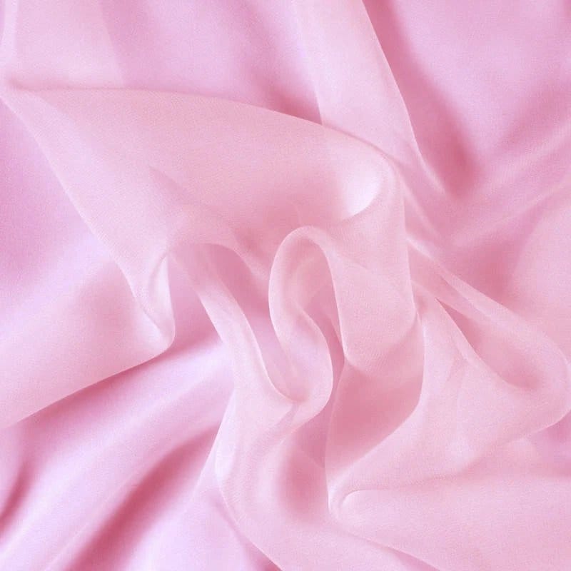 Soft pink silk chiffon fabric with a smooth, sheer texture and elegant flowing folds