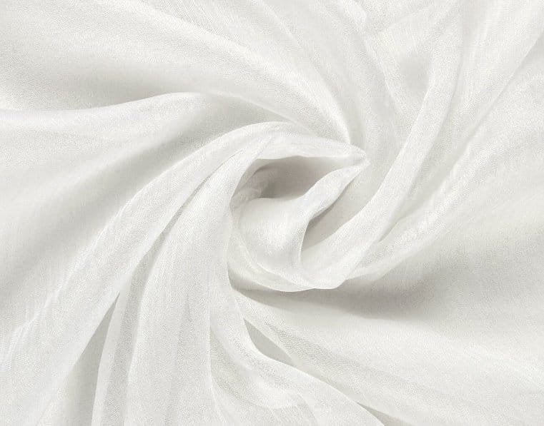 White nylon chiffon fabric swirled into soft folds symbolizing classic timeless textile development