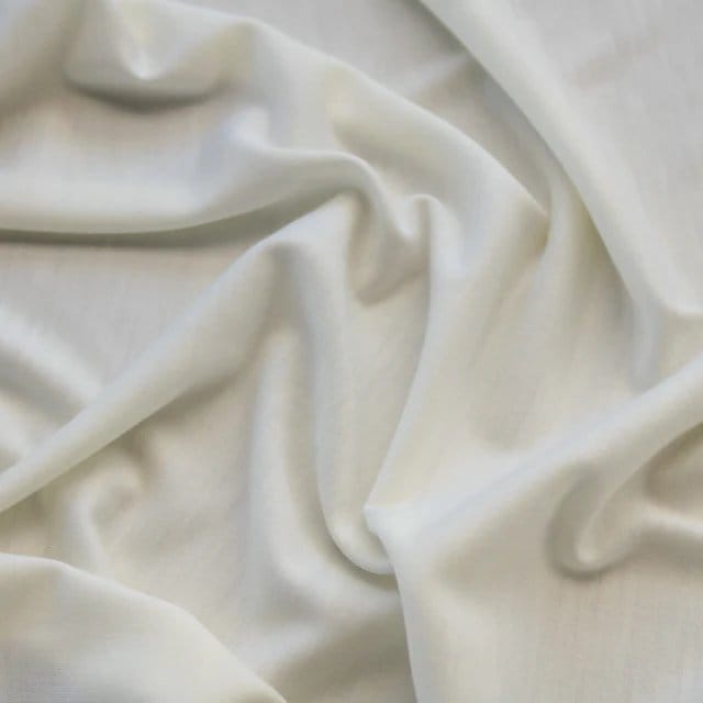 Close up of wool jersey fabric showing smooth surface soft drape and stretch