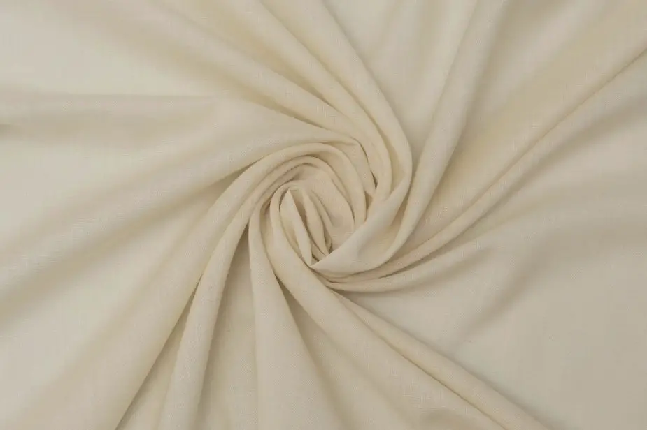 Close up view of wool delaine fabric showing smooth texture and elegant drape