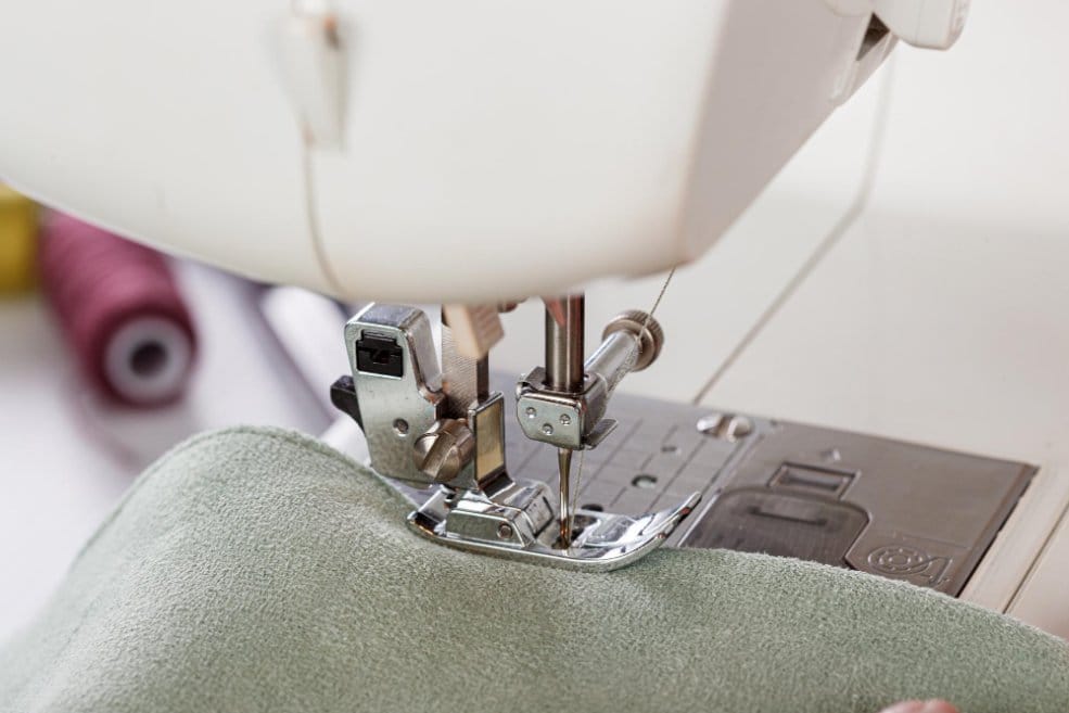 Sewing machine stitching double cloth wool fabric showing tailoring and sewing techniques