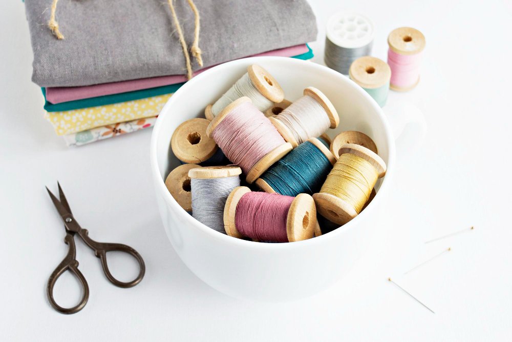 Sewing tools and thread spools used for working with venetian wool fabric