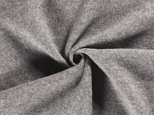 Close up of boiled wool fabric showing soft texture, dense structure, and flexible drape.