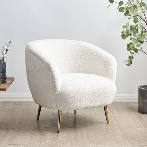 Bouclé fabric upholstered accent chair showing texture, softness, and modern home decor use