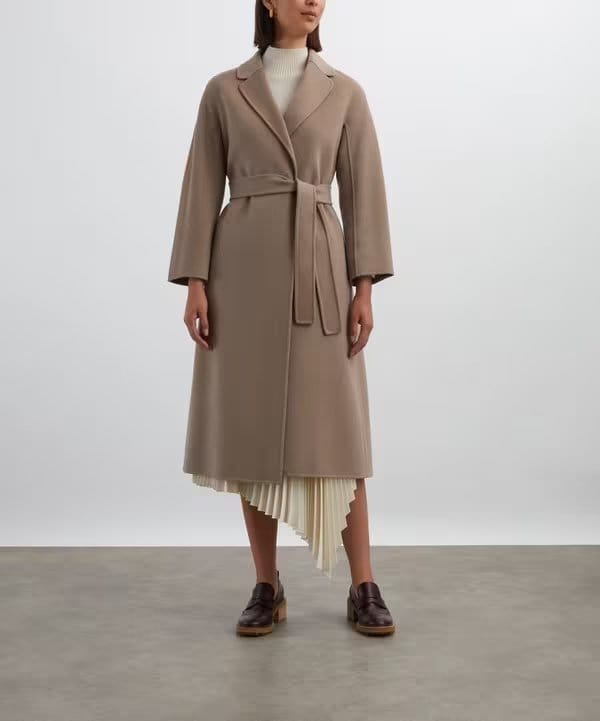 Tailored long coat made from wool broadcloth fabric showing smooth finish and structured drape