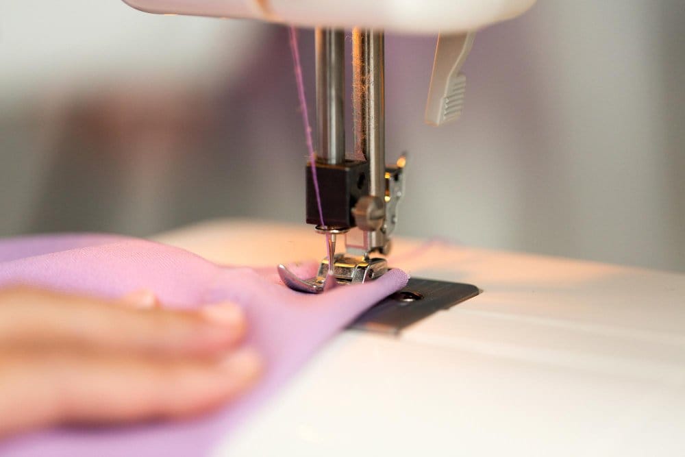 Sewing machine stitching chiffon fabric using fine needle and careful technique